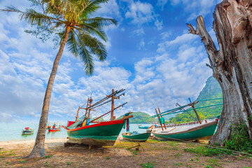 Longtale boat on the white beach at Phuket, Thailand. Phuket is a popular destination famous for...