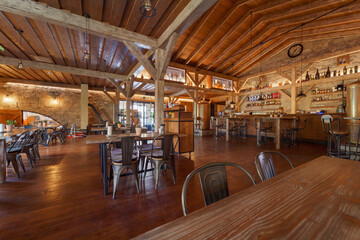 Interior of modern restaurant and bar with wooden ceiling