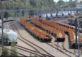 A freight railway yard in Sydney with orange empty rail cars