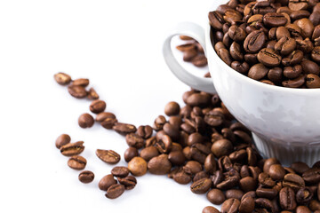Cup filled with a roasted coffee beans on white background