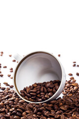 Cup filled with a roasted coffee beans on white background