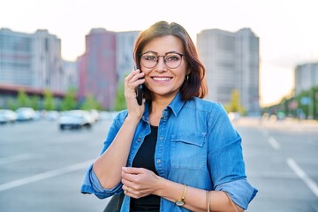 Outdoor portrait of a beautiful successful 40s woman