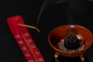 Fototapeta na wymiar Aromatic stick and gum olibanum on black table