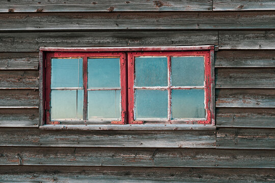 old routed vernacular window of a barn wall