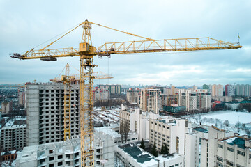 Construction crane on the background of the construction site.