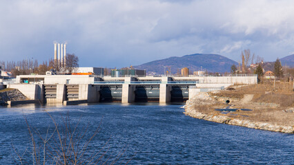 View of the hydro-electric power plant Puntigam in Graz, Austria at the river Mur on a stormy...