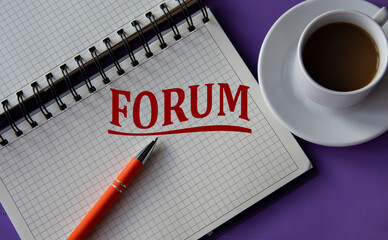 FORUM - acronym in a white notebook on a purple background with a cup of coffee