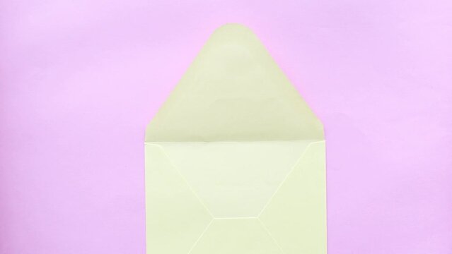 Creative Valentine's Day concept. Envelopes, valentines, a heart on a pink background. Flat layout, top view, copy space. A man is preparing a surprise for his beloved. Holiday, love