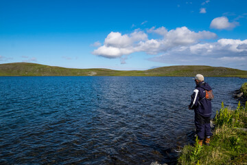 Fototapeta na wymiar fisherman by a lake