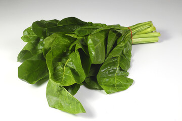 Bunch of fresh chard leaves on white background. Top view.