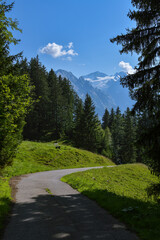 Windy road in Swiss Alps with majestic view on Wetterhorn peak