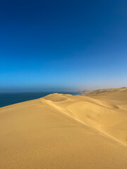 Sandwich Harbour in Namibia at the coast of the Atlantic Ocean. Sandy beach.