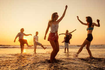 multicultural multinational happy people running into the sun carefree and happiness, vacation on...