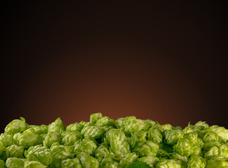 The green hop cones heap on brown background. Brewery concept.