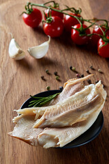 Smoked trout fish with herbs, garlic and cherry tomatoes