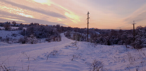 Forest and snowy road in winter sky