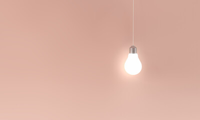 Hanging illuminated light bulb in pink background. idea or innovation concept.