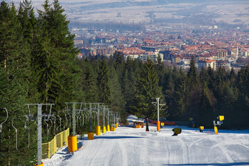 ski resort in Bulgaria, snow-covered track with lift, winter day