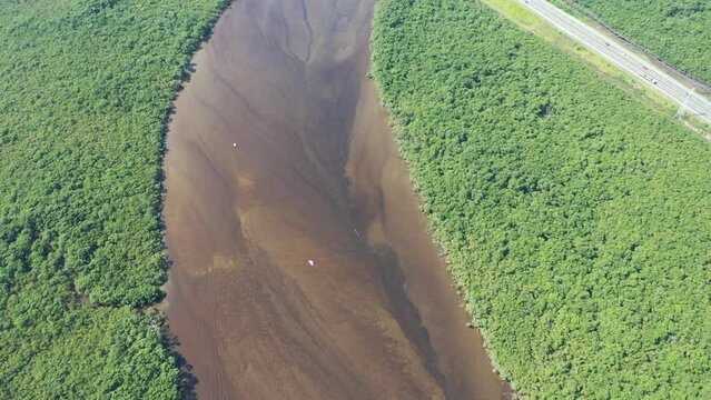 Panning wide view of peaceful darm river at coastal city of Itanhaem Sao Paulo Brazil. South coast of state of Sao Paulo. Tropical scenery. Travel destinations. Popular tourism landmark.