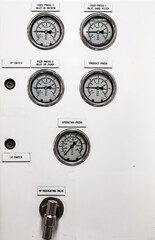 Dashboard with pressure gauges for various systems inside the ship's engine room.