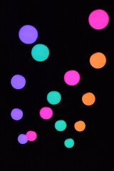 Glowing lanterns in the form of a circle on a black background. Abstraction, dna