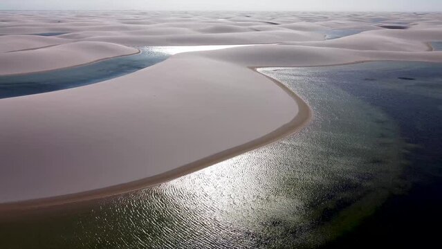 Sunset at sand dunes and rain water lagoons at northeast brazilian paradise. World travel destinations. Tropical scenery. Lencois Maranhenses Maranhao Brazil. 