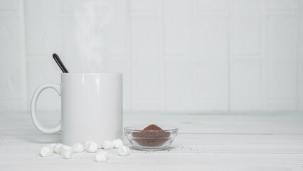 Fototapeta na wymiar Hot chocolate with marshmallow on top of white counter