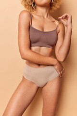 Beauty and body care concept. Unrecognizable slim female model dressed in cropped top and panties...