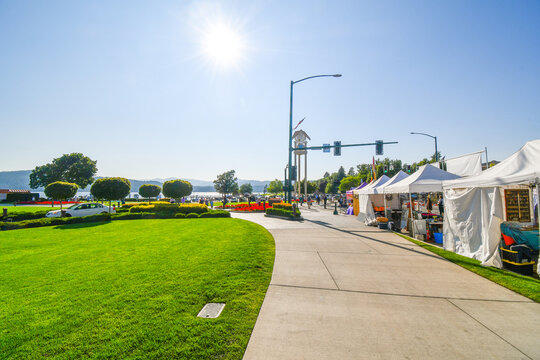 Sellers And Artists At Their Booths Along Sherman Ave. With The Resort And Lake In The Distance During A Local Art Festival In The Resort Lakeside City Of Coeur D'Alene, Idaho, USA.