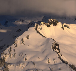 Aerial panorama of dramatic mountain peak and clouds at sunset