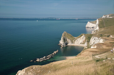 Man o' War Bay, near Durdle Door, and the view West along the Jurassic Coast, Dorset, UK, from...