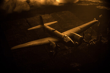 German Junker (Ju-88) night bomber at night. Artwork decoration with scale model of jet-propelled plane in possession. Toned foggy background with light. War scene.