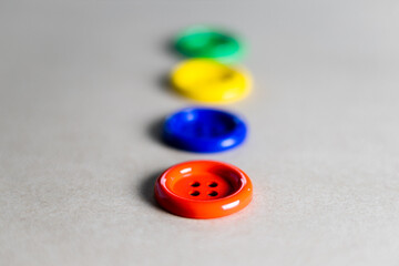 Different colored buttons on a gray background with selective focusing