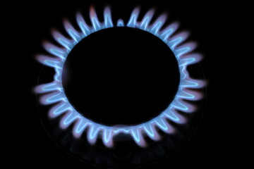 Close up of burning gas burner on a kitchen stove in home
