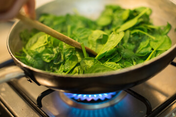 Spinach in a pot with lit fire