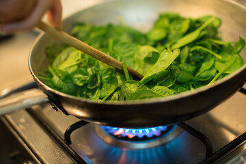 Spinach in a pot with lit fire