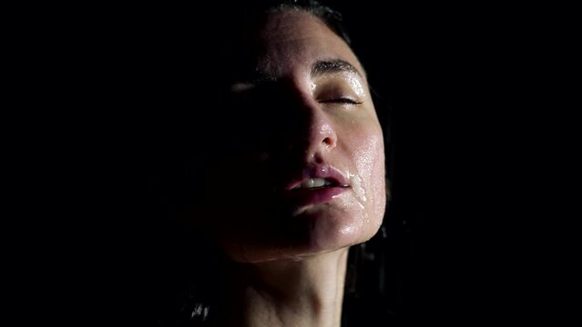 natural beauty of female face under water flow in shower, sensual portrait, excited woman