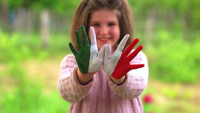 Mexico flag painted on teen girl hands, focus on hands. Mexican Independence Day 16 September. February 5 Day of Conference. February 24 National Flag Day