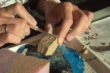 Fototapeta premium Production of clay products at the master class on ceramics in the form of a house. 