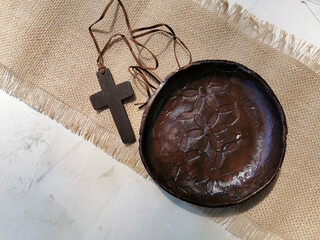 A wooden Christian cross on white old background. Christianity Concept. Flat lay. Copy space.
