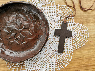 A Christian cross on wooden background. Christianity Concept. Flat lay. Copy space.