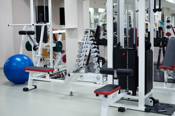Fototapeta na wymiar gym modern fitness center room. empty hall with simulators on different muscles. no people