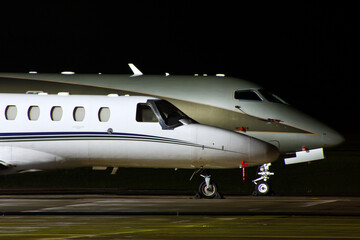 Business jets parked on the apron at night
