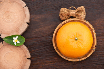 Orange fruit and flowers on an old wood background.top view