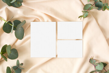 Wedding suite mockups with eucalyptus leaves on the nude fabric