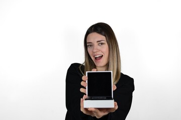 Fototapeta premium Beautiful happy young woman in casual clothes is holding in her hand empty box on a white background isolated. She shows emtpy jewellery or gift box to the camera. Surprise and gift concept photo. 