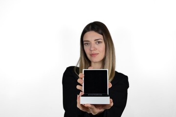 Beautiful smiling young woman in casual clothes is holding in her hand empty box on a white background isolated. She shows emtpy jewellery or gift box to the camera. Surprise and gift concept photo.