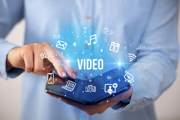 Businessman holding a foldable smartphone, social media concept