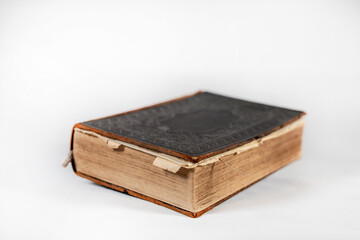 100 years old hardcover bible from side on white background