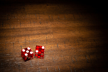 Professional casino-style dice on a wooden table with room for copy. 